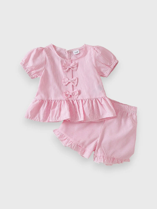 Pink peplum puff-sleeve top with bow details and matching shorts