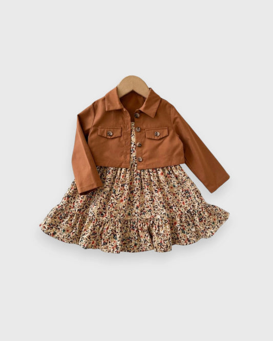 Brown cropped jacket paired with a tiered ditsy floral dress