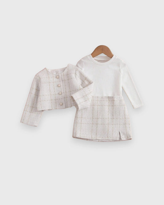 Girls' pale tweed jacket beside a dress with white long-sleeve bodice and matching tweed skirt.