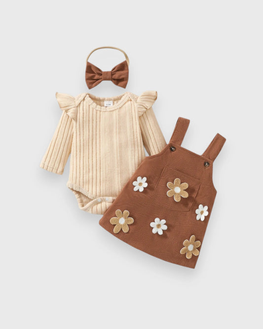 Cream ribbed baby bodysuit, brown daisy-applique pinafore and matching bow headband.