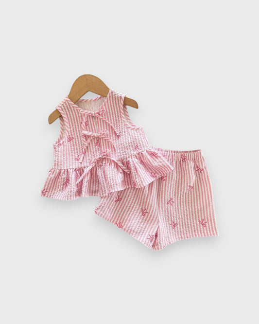Pink sleeveless ruffle peplum top and striped shorts